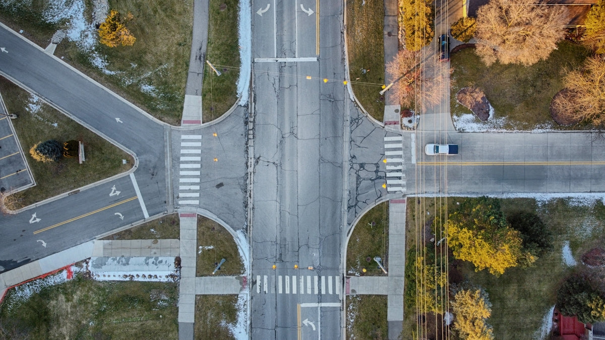 an aerial view of a street intersection in the fall