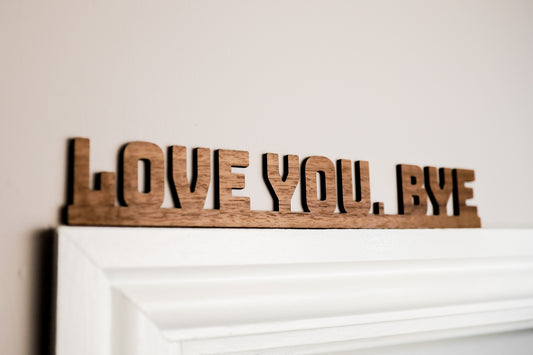 love you bye sign used as a door topper made from walnut