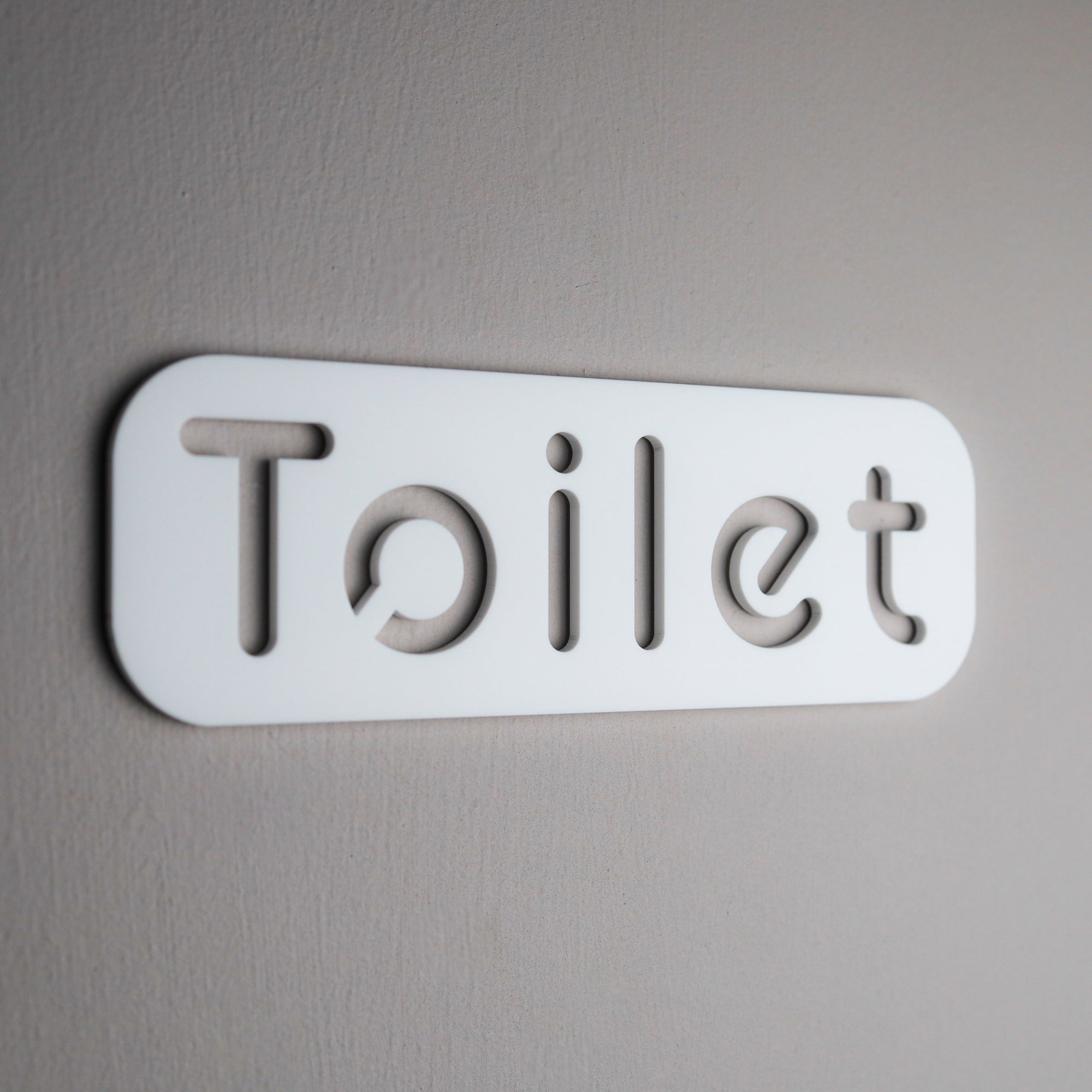 Sleek and stylish bathroom door sign with self-adhesive backing for easy installation.
