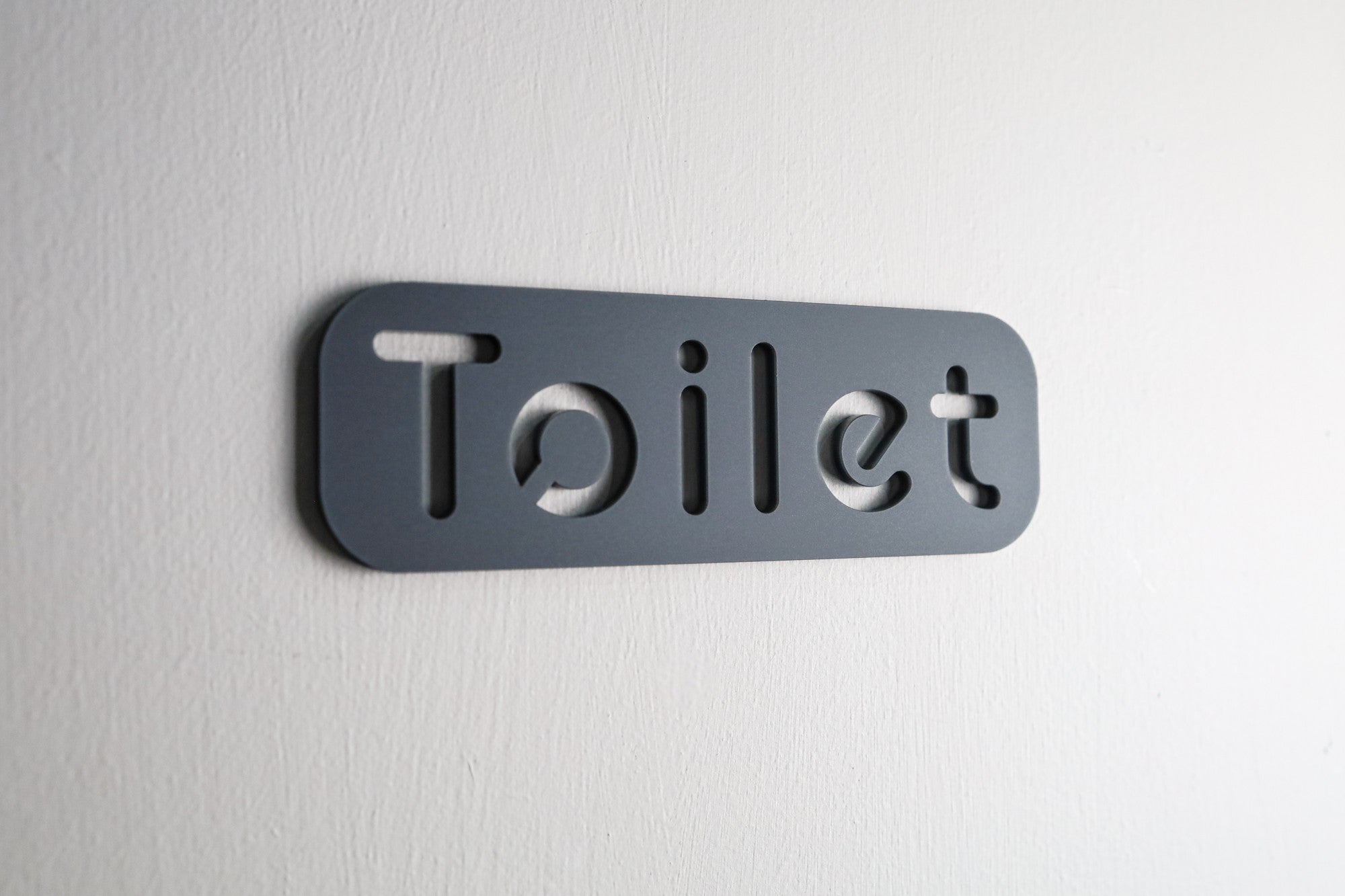 Elegant WC door sign featuring a refined stone texture finish and minimalist design.